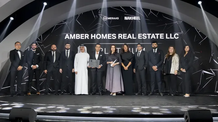 Ambreen Qureshi and the Amber Homes Real Estate team on stage — Platinum Agency 2024