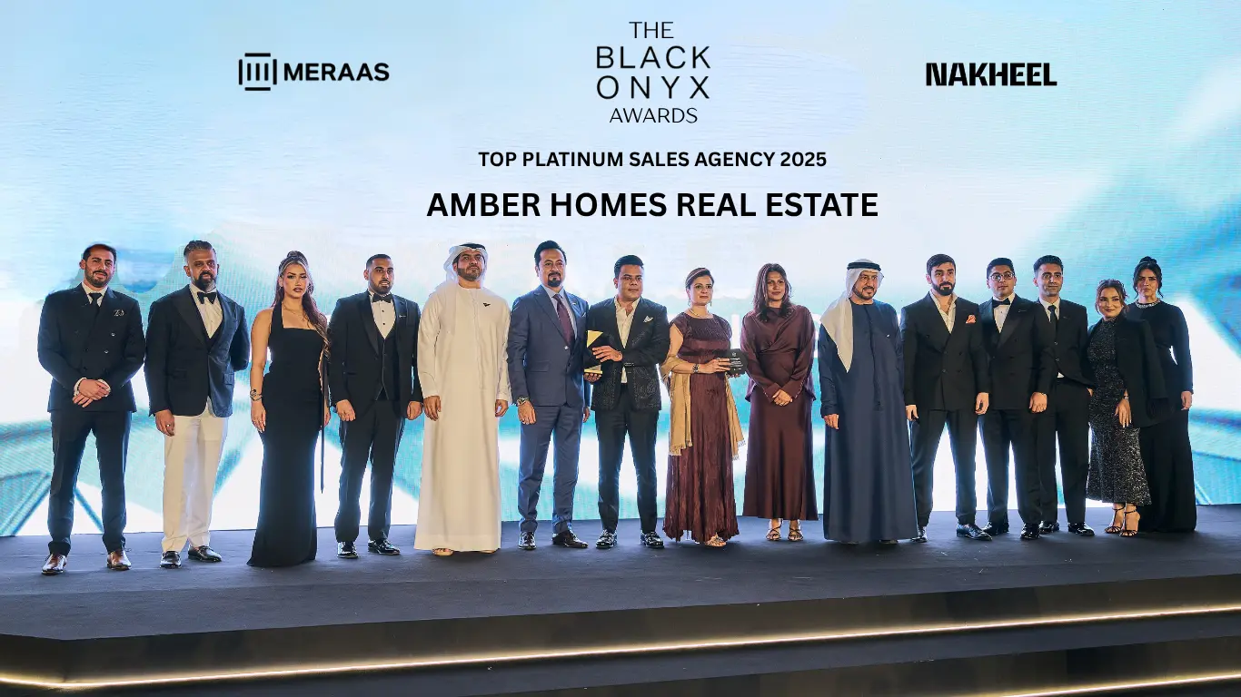 Ambreen Qureshi and the Amber Homes Real Estate team on stage — Platinum Agency 2025